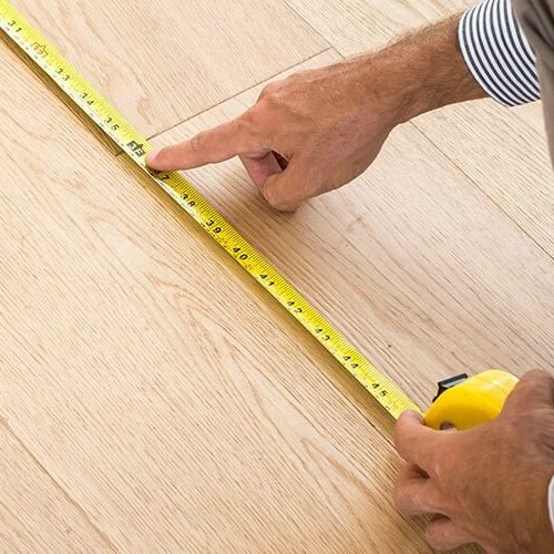 Man measuring floor | Yates Flooring